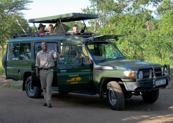 Serengeti-3285.jpg - Our guide Chris with  our brand new stretch Landcruiser.  Steve is reading the map, then Heidi and Debbie in front with the camera.